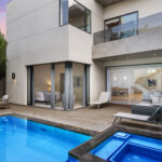 Southern California outdoor living space with multiple seating zones and pool.