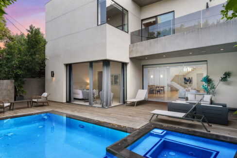 Southern California outdoor living space with multiple seating zones and pool.