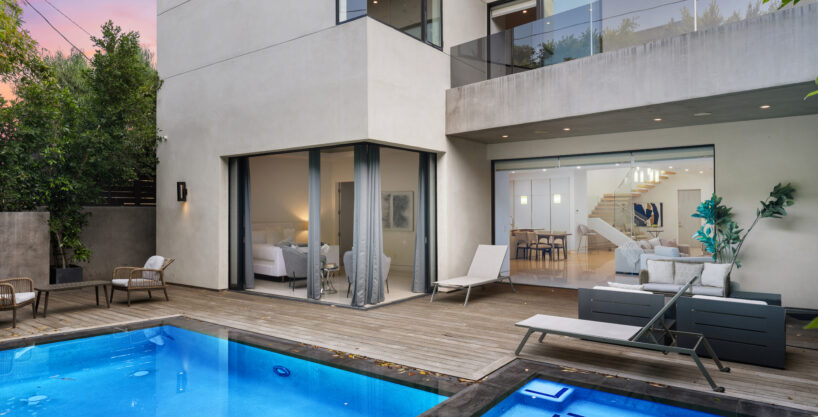 Southern California outdoor living space with multiple seating zones and pool.