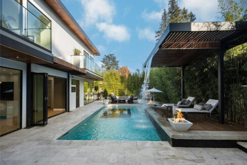 Daytime pool view with tropical landscaping at Dixie Estate Studio City