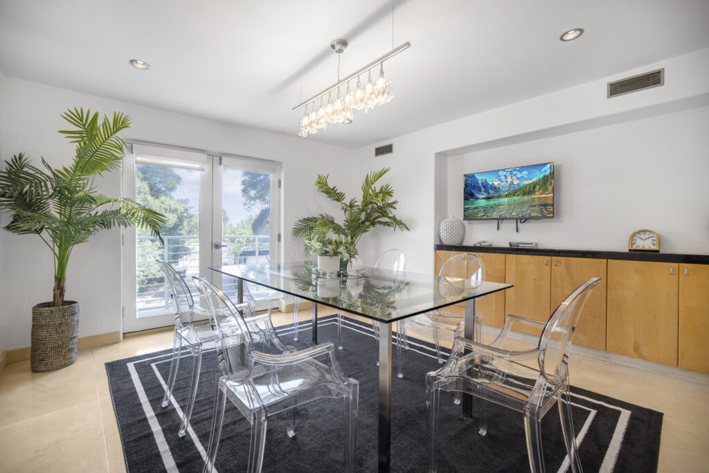 Upper-level sitting area with smart TV and sleek modern decor.