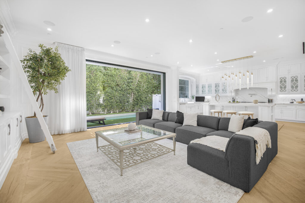 Contemporary principal living space with soaring ceilings and floor-to-ceiling glass.
