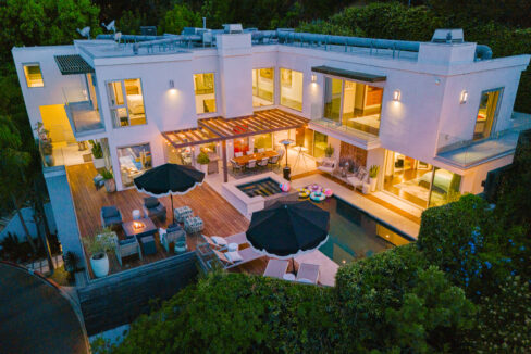 Pinnacle Canyon Hollywood Hills luxury villa exterior at night with pool lighting