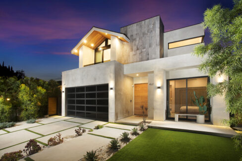 Twilight exterior of Riverside House showing manicured lawn and private pool in Valley Village Los Angeles