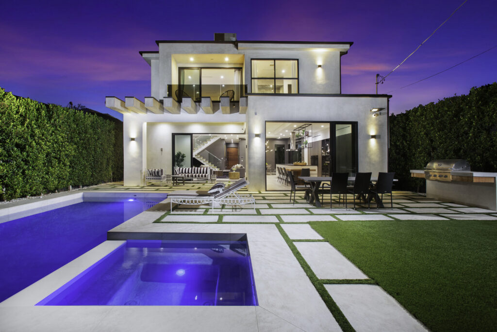Glowing blue pool at night at Riverside House, a luxury 4-bedroom vacation rental in Valley Village