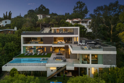 Magical twilight exterior shot of the multi-tiered luxury mansion.