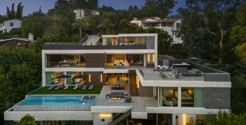 Magical twilight exterior shot of the multi-tiered luxury mansion.