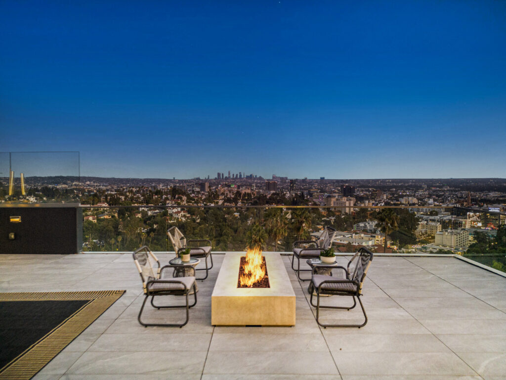 Expansive rooftop terrace offering panoramic Pacific Ocean vistas at sunset.