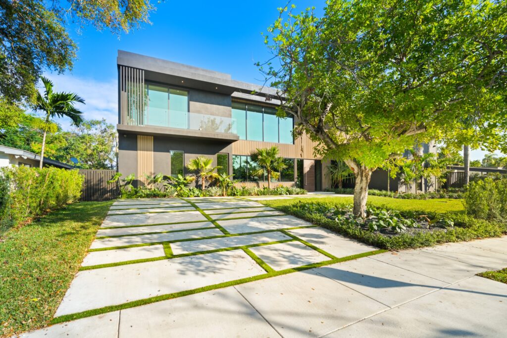 Front exterior with modern driveway, clean architectural lines, and landscaped surroundings