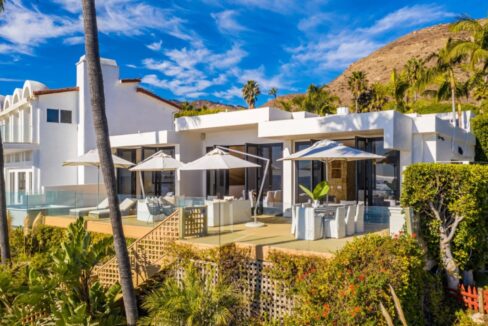 Aerial view of the home with pool and ocean