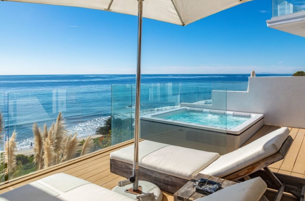 Shaded daybed lounger by the pool with ocean views