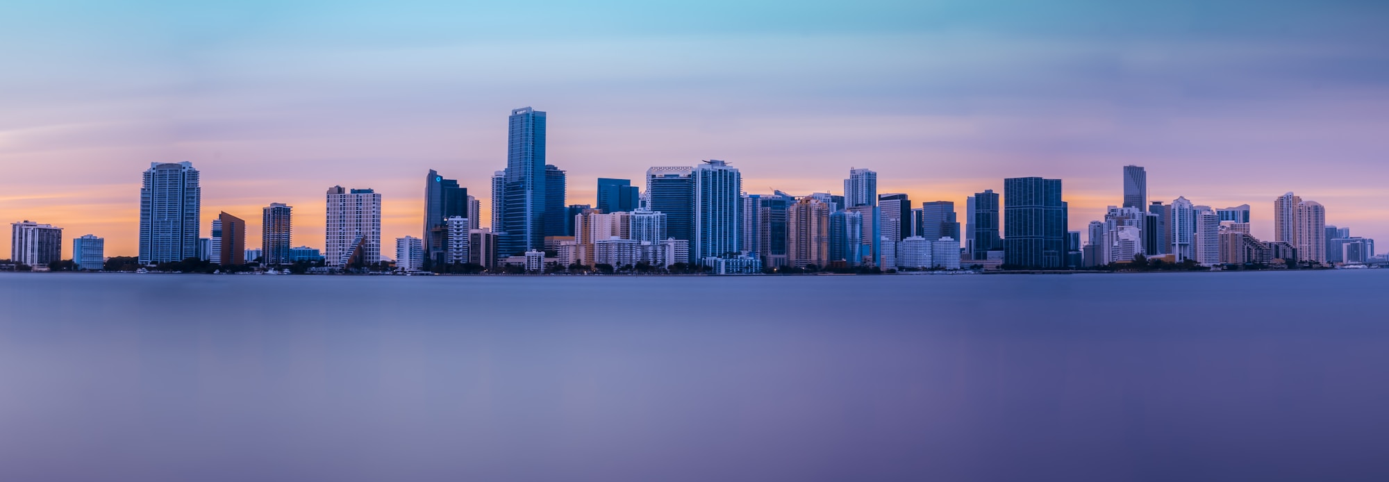 The Brickell and Downtown Miami skyline across Biscayne Bay at sunset