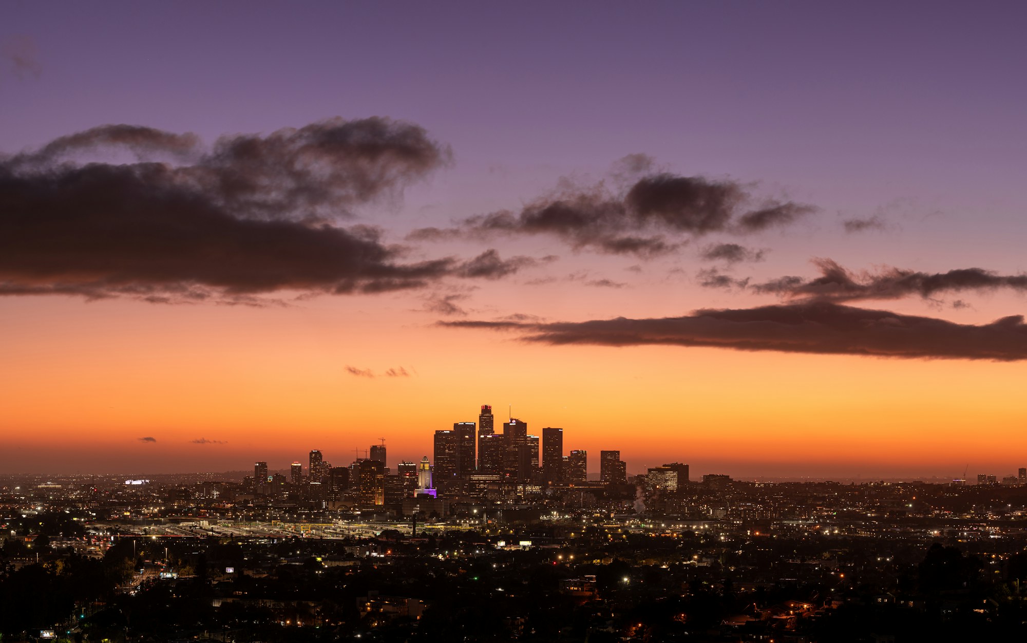 The Los Angeles basin and Downtown skyline at sunset, seen from the hills