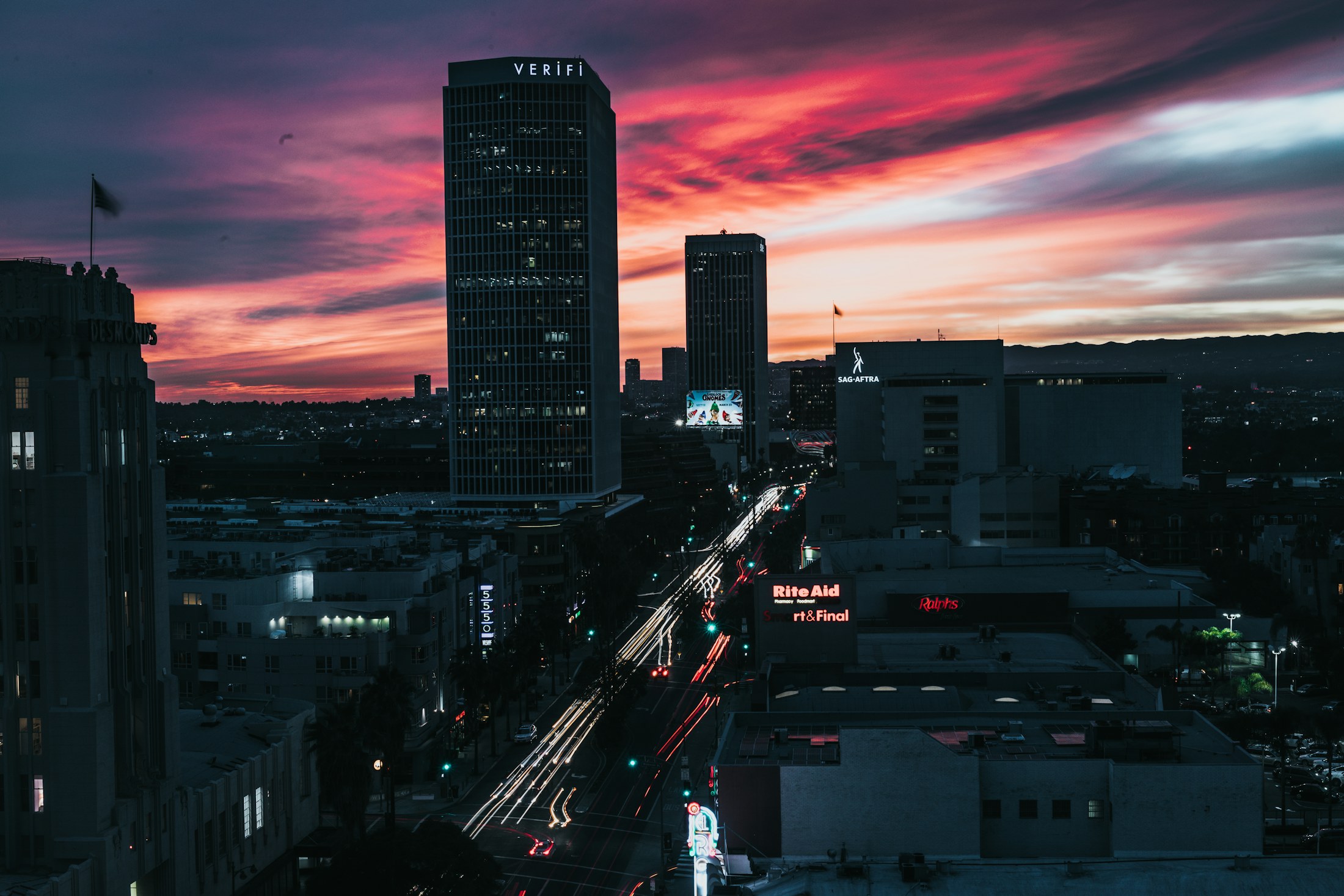 West Hollywood and the Sunset Strip at dusk under a pink sky, seen from above